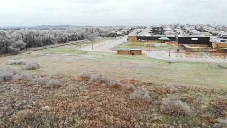 Flying-over-a-verry-frosty-field-with-many-frozen-bushes-and-grasses