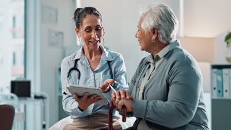 a doctor and her patient smiling and talking in an office