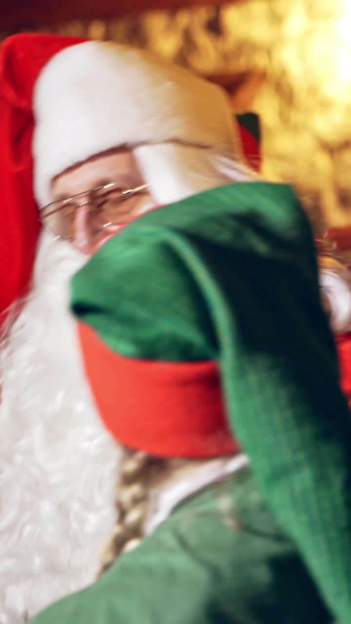 Santa Claus preparing for eve. Portrait of Santa Claus preparing for Christmas Vertical video