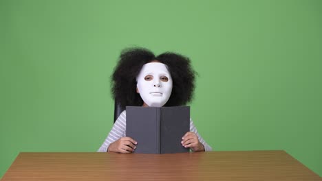 young cute african girl with afro hair against green background