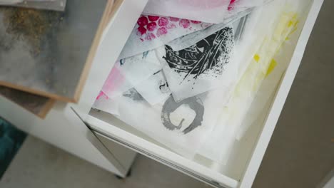 Drawer-in-artists-studio-of-paper-swashes,-creatively-designed-for-layered-canvas