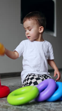 preschool fun game learning. little cute boy playing with colorful toy. vertical video