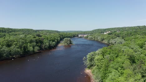 Low-aerial-shot-flying-over-the-Saint-Croix-River-towards-Saint-Croix-Falls,-Wisconsin