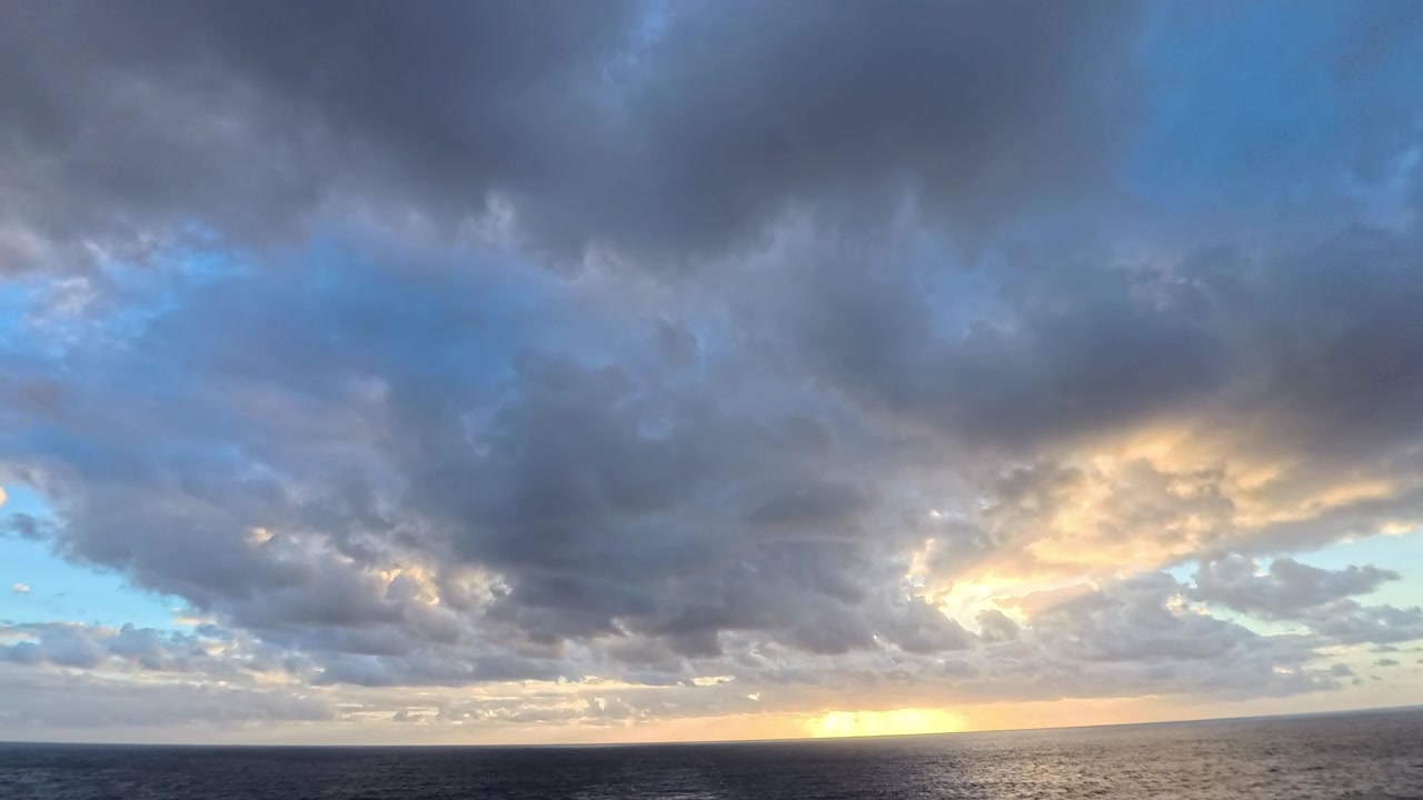 Vast Ocean Horizon with Dramatic Clouds and Golden Sunset
