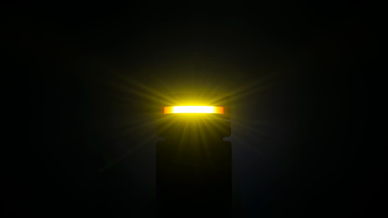 Starting glowing LED bar atop dark pedestal ramping brightness in studio emitting halo rays