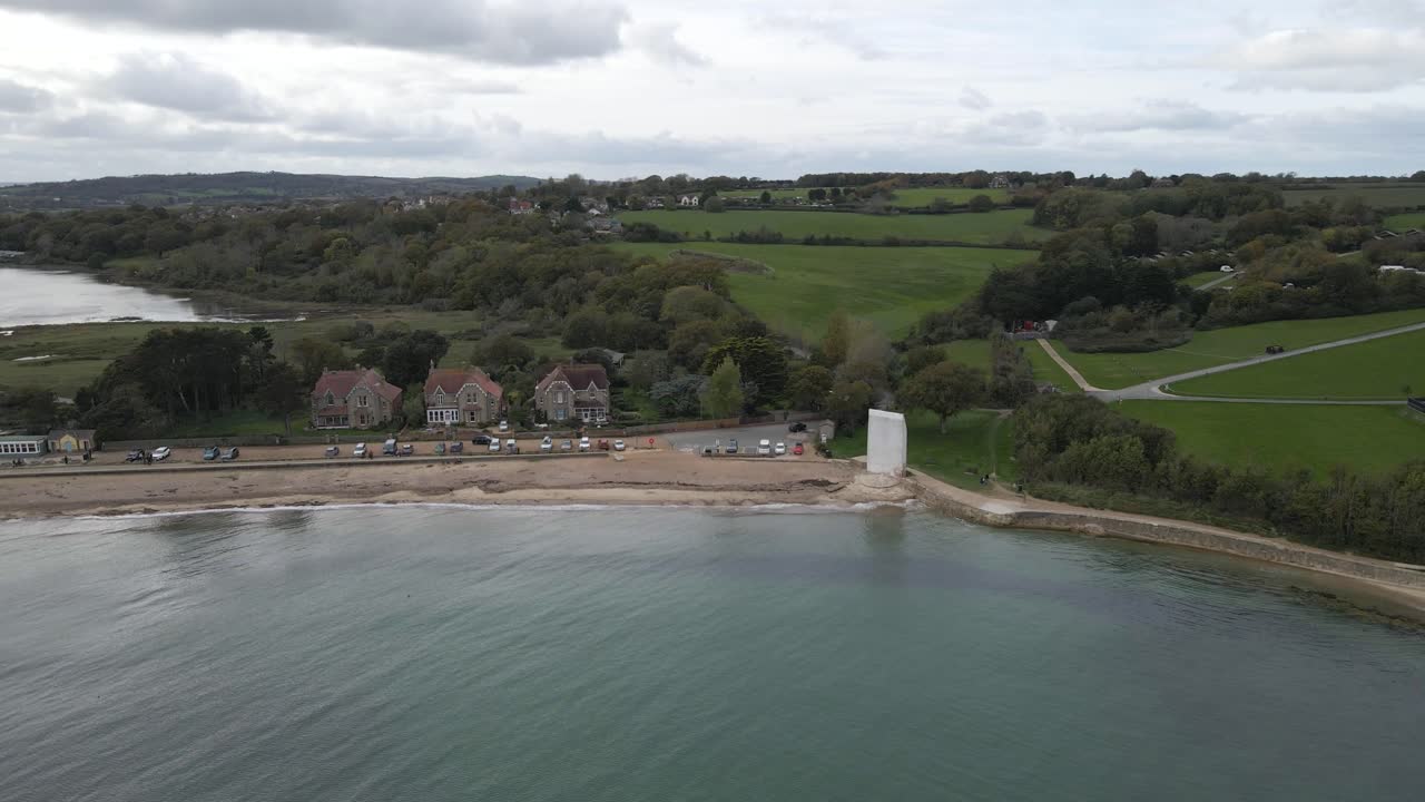 Aerial view of St Helens village named in dedication to St Helena Church, a destroyed church built in the 12th century, Cluniac priory. Only the tower of the church remains, drone moving left