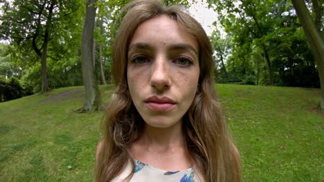 a woman with a strong allergy struggles with sinus pain in the park