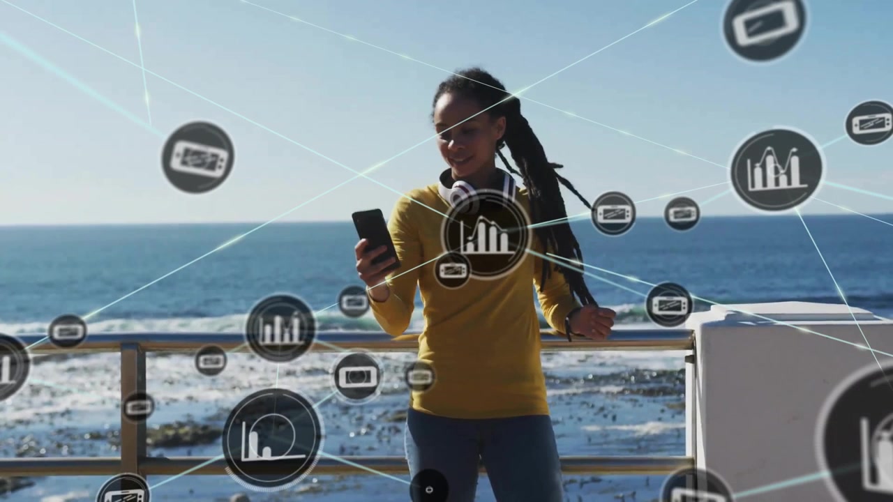 Animation of network of connections with icons over woman using smartphone by sea