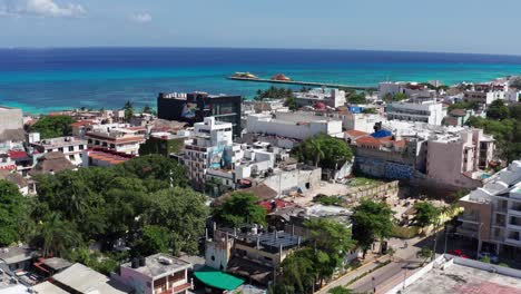 low aerial shot flying over playa del carmen towards the caribbean sea and ferry landing to cozumel, mexico