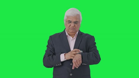 Stressed-Indian-senior-manager-waiting-for-someone-Green-screen