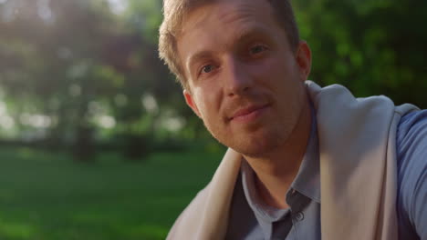 Closeup-handsome-blond-man-posing-in-sunlight.-Smiling-guy-look-in-camera