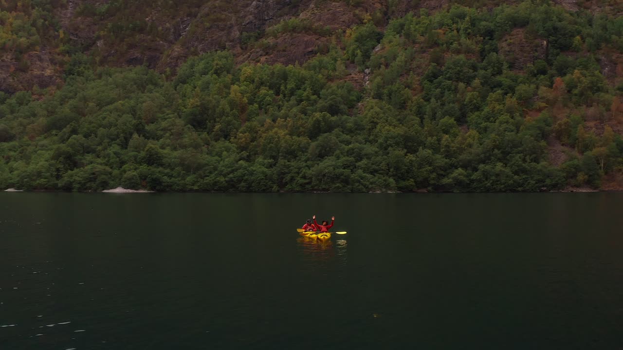 Kayaking in Norway with a peaceful landscape of lush greenery and calm waters
