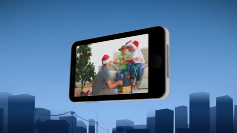 teléfono inteligente que muestra a una familia celebrando navidad