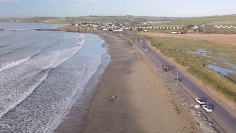 coastal road, sandy beach and slow motion moving waves in winter