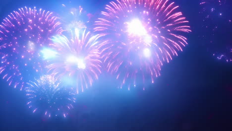 cinemagraph of happy new year text in red and white over pink fireworks exploding in night sky