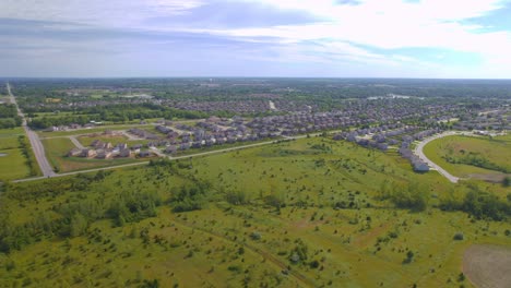 extremely wide view by a drone flyover aerial view missouri fields and suburbs prime real estate in a new neighborhood