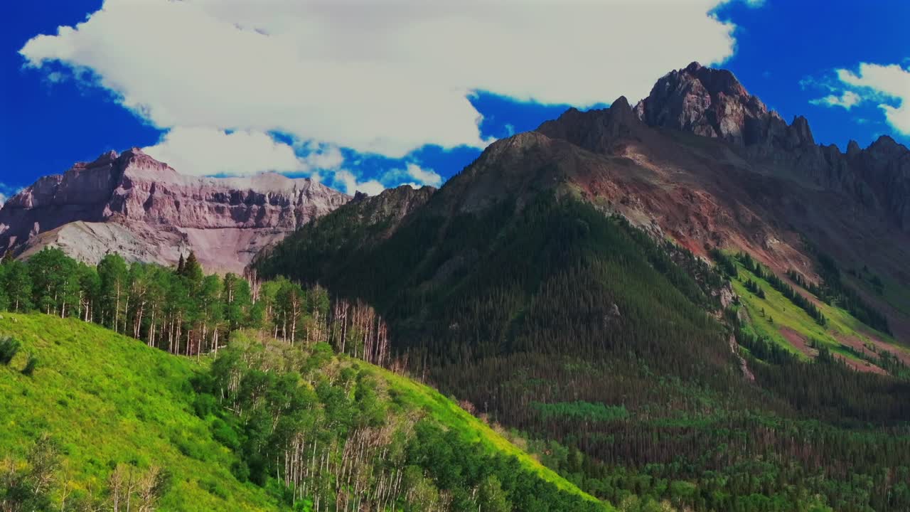 Mount Sneffels 14er peak Wilderness Blue Lakes Trailhead Last Dollar Road Ridgway Colorado aerial drone summer Uncompahgre National Forest Aspen trees blue skies clouds upward motion