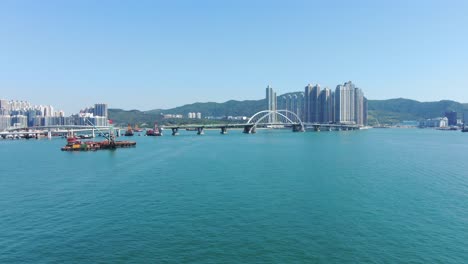 Hong-Kong-cross-bay-link-construction-project,-a-dual-two-lane-bridge-connecting-Tseung-Kwan-O-Lam-Tin-Tunnel-to-Wan-Po-Road,-Aerial-view