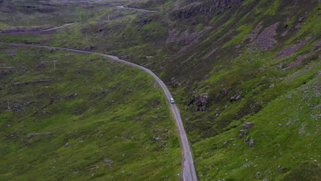 drone shot following a van on bealach na ba applecross road through the mountains of the applecross peninsula, in wester ross in the scottish highlands