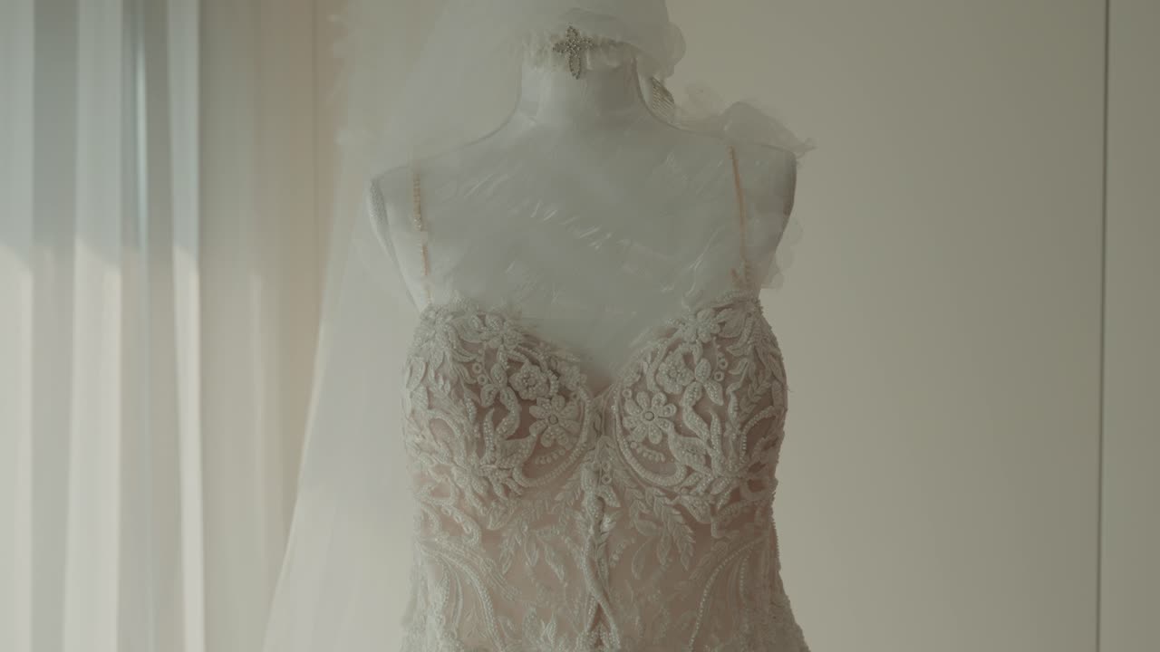 Ethereal wedding dress with floral embroidery and flowing fabric in soft light