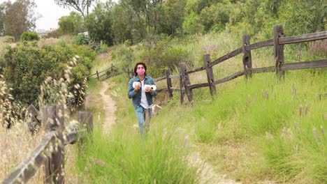 A-man-walks-home-on-a-path-with-toilet-paper-during-the-Covid19-coronavirus-pandemic-epidemic