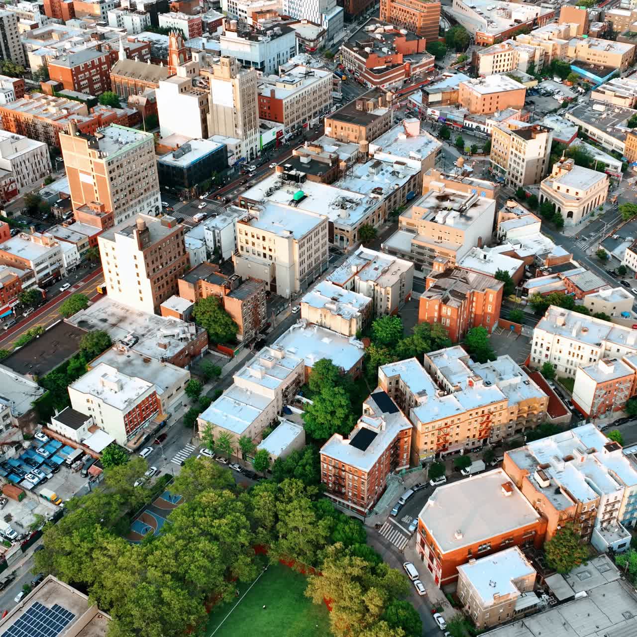 Baseball field among the trees in the panorama of the city. New York scenery from bird's eye view