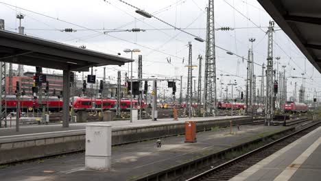 frankfurt main station platforms with overhead electric power lines and regional trains in background