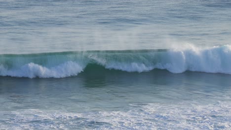 waves forming and crashing on the shore