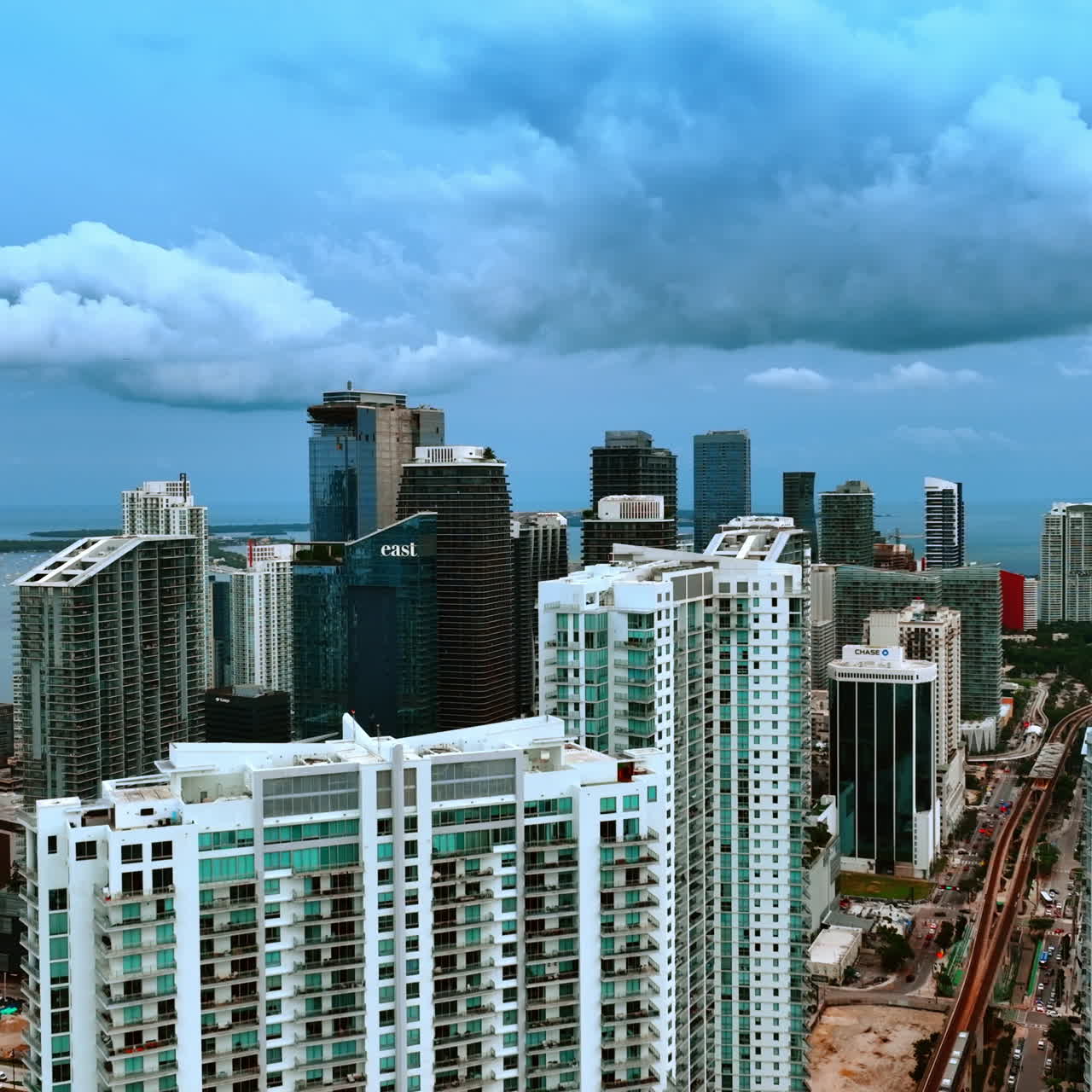 Beautiful high-rise modern blocks of flats in the American city downtown. Skyscrapers under the dramatic skies and heavy grey cloudscape.