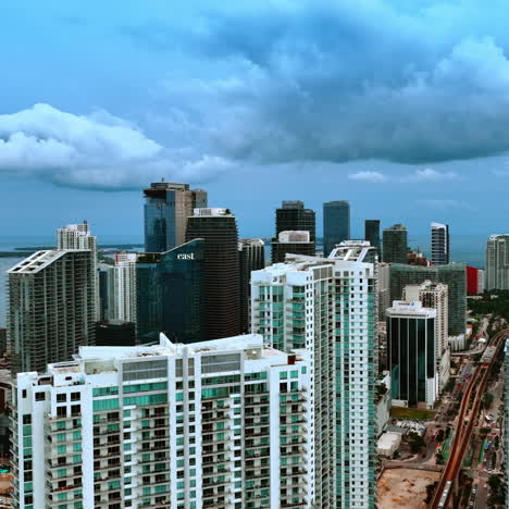 beautiful high-rise modern blocks of flats in the american city downtown. skyscrapers under the dramatic skies and heavy grey cloudscape.