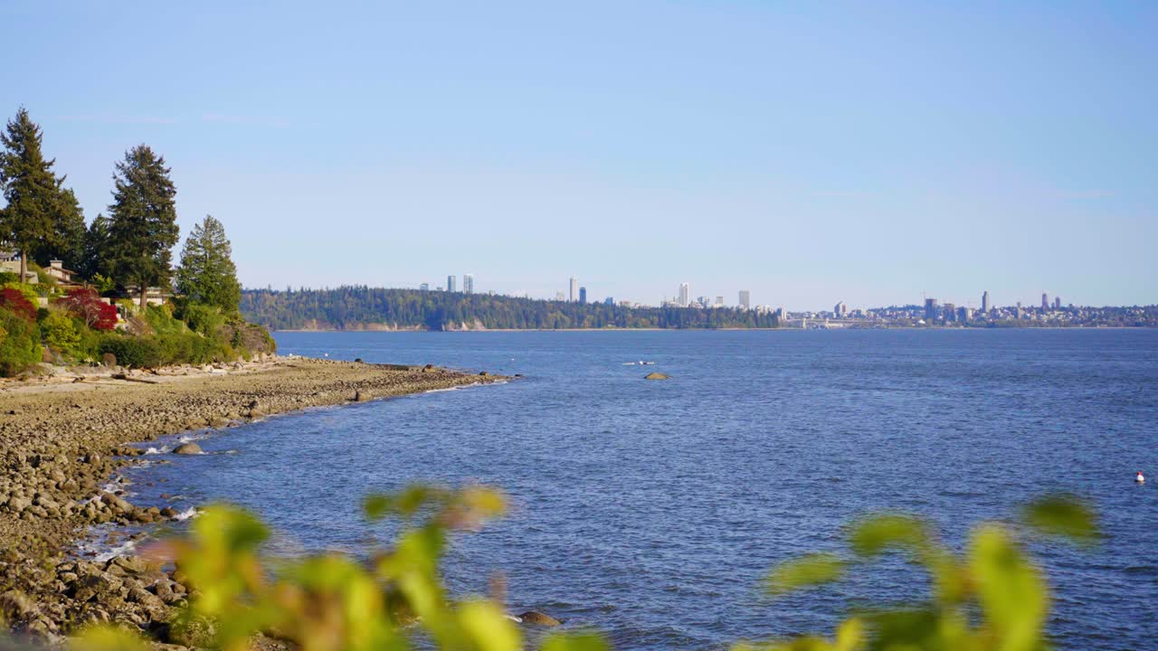 a cinematic shot of the calm and serene blue waters and blue skies of West Vancouver