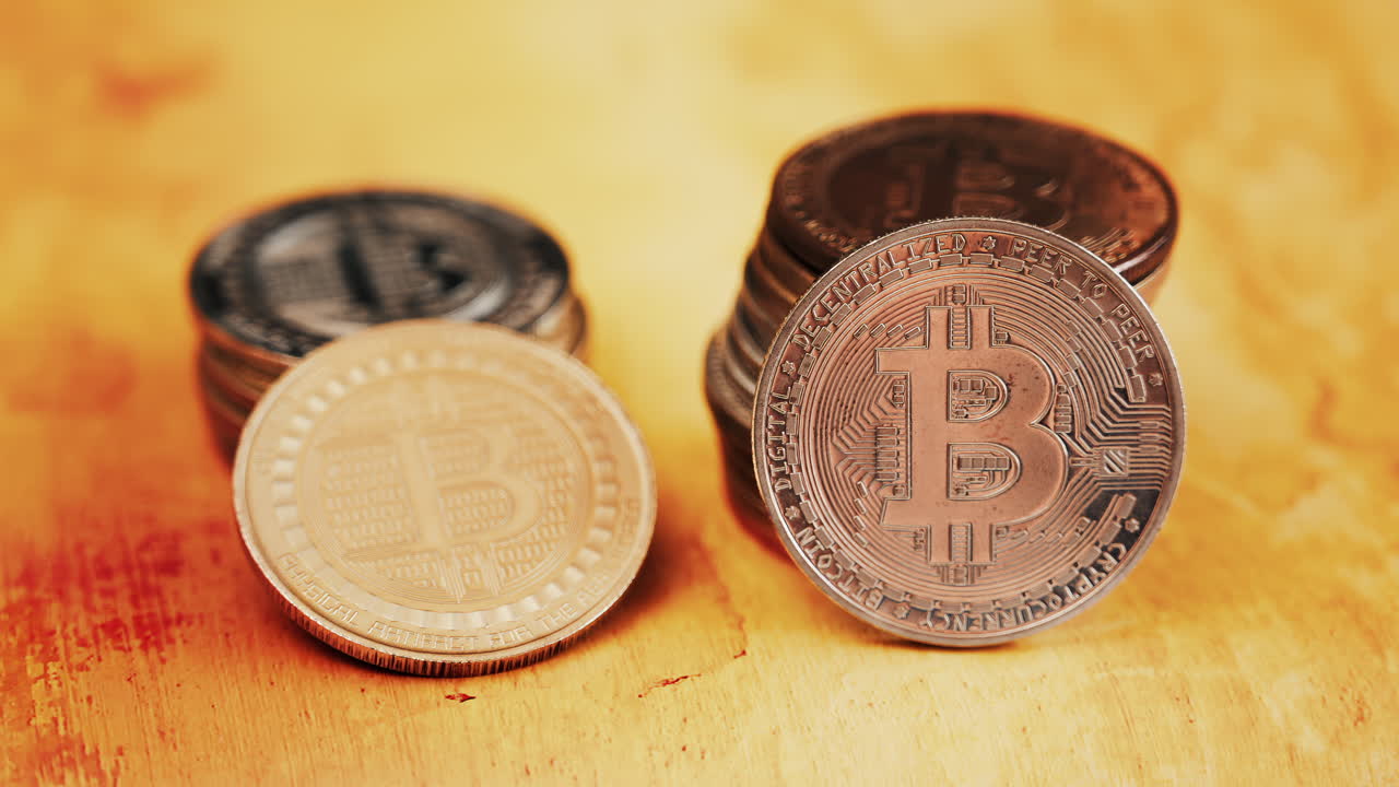 Close up of shiny physical Bitcoin coins stacked on a table
