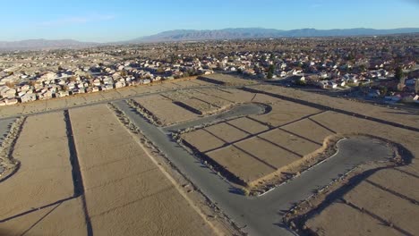 Aerial-over-desert-reveals-housing-tracts-and-empty-lots-in-the-desert