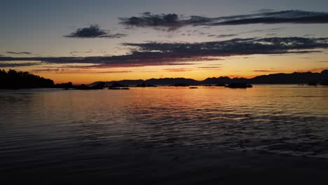 gorgeous sunset over water - drone dolly towards sun