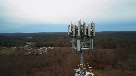 Aerial-Reverse-Shot-of-Cell-Phone-Tower-in-Forest