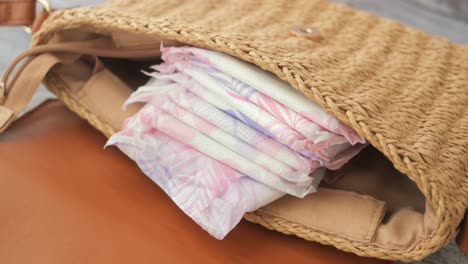 sanitary napkins in a straw bag