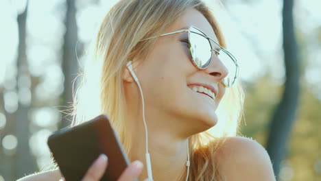 Eine-Frau-Mit-Vorbildlichem-Auftritt-In-Sonnenbrille-Hört-Im-Urlaub-Musik-In-Der-Sonne-Die-Strahlen-Der-Su