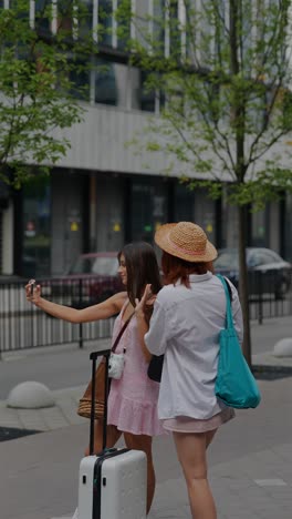 two women taking a selfie on the street