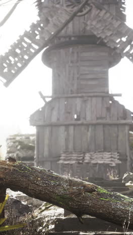 a wooden windmill in a foggy forest