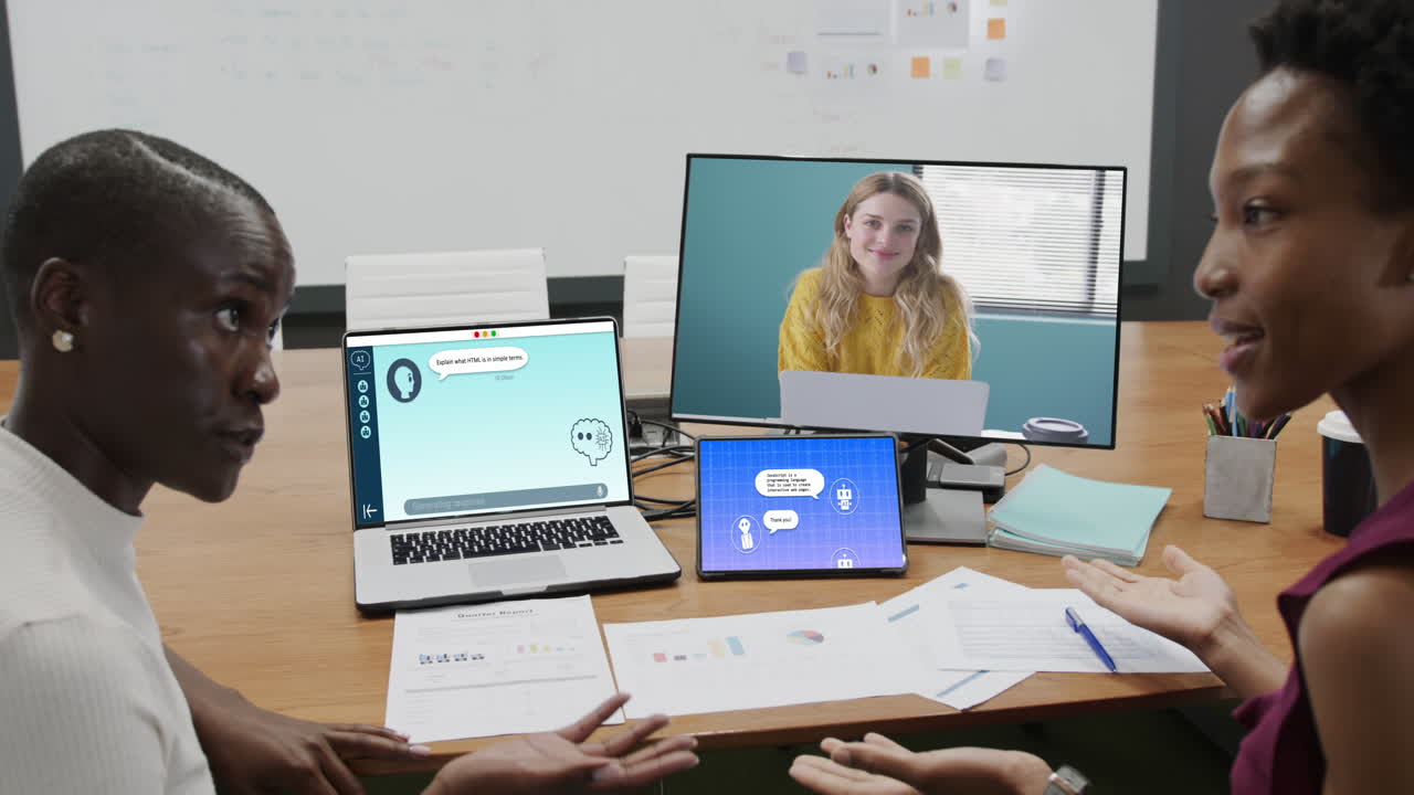 Diverse businesswomen having video call and using laptop with digital chat on screen in office
