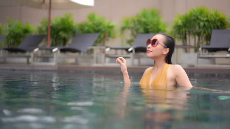 Slow-Motion-of-Pretty-Asian-Female-Enjoying-in-Swimming-Pool-During-Her-Vacation