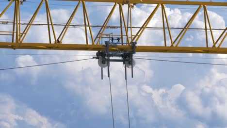 yellow construction crane working high in the sky