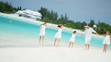 caucasian family having fun playing together on beach