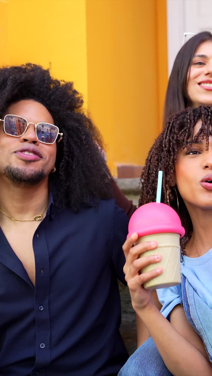 Friends taking selfies and making videos