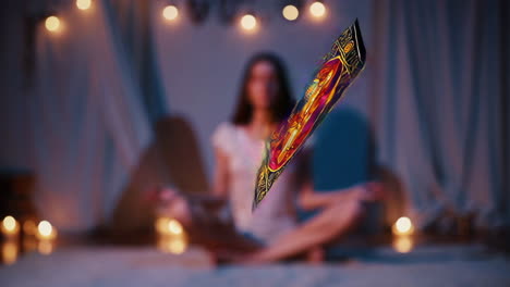 woman meditating with tarot card