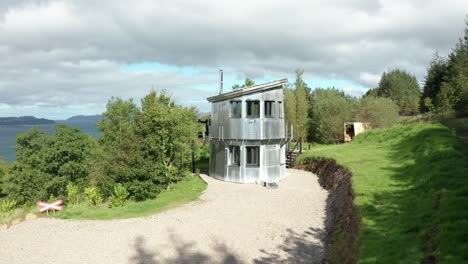 aerial reveal - rising shot revealing the sound of mull behind the modern home