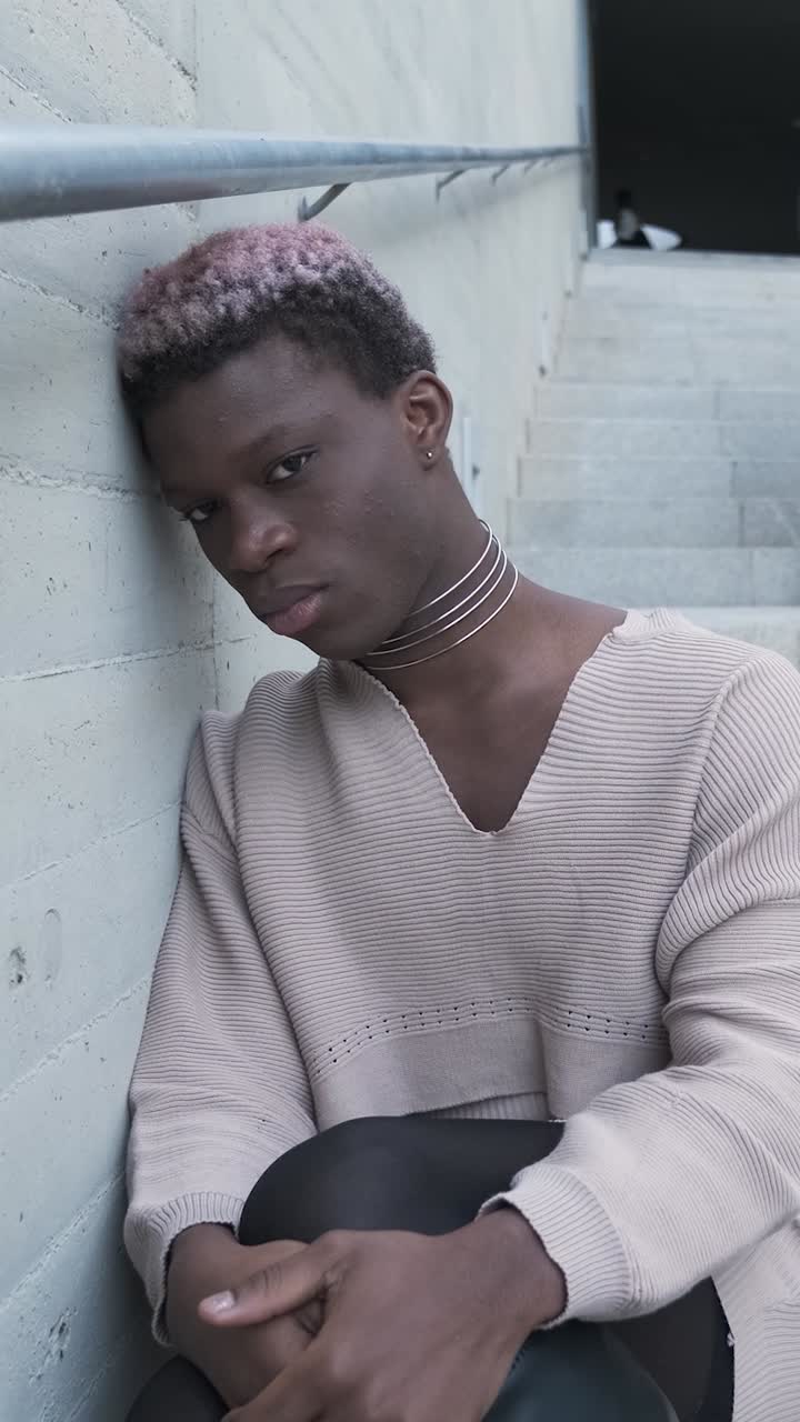 Sad african transgender person sitting