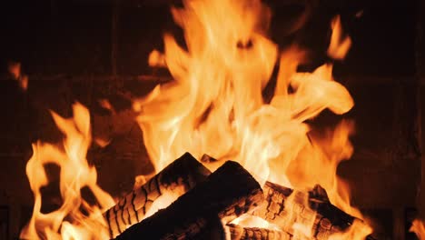 fire in the fireplace in lobby of large resort hotel in mountains slow motion. dry burning firewood in fireplace. pattern of bright orange flame. relax. family holidays