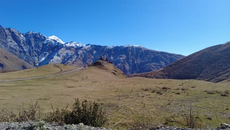 beautiful caucasus mountains and stepantsminda church - the main attraction in georgia