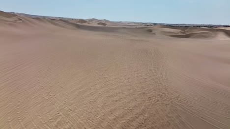 Desert-sand-dunes-and-city-town-of-Peru